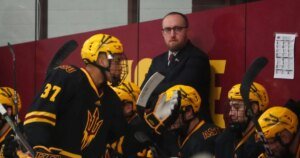 Arizona State hockey head coach Greg Powers watches his team as they …