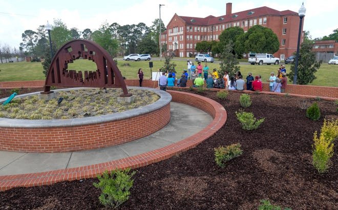 Residents celebrate the expanded garden at Oak Street and Fairview Avenue in Montgomery, Alabama, on Saturday, March 25, 2023.