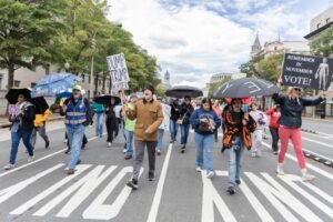 In the nation’s capital, rallygoers hoist umbrellas at No Kings get-o…